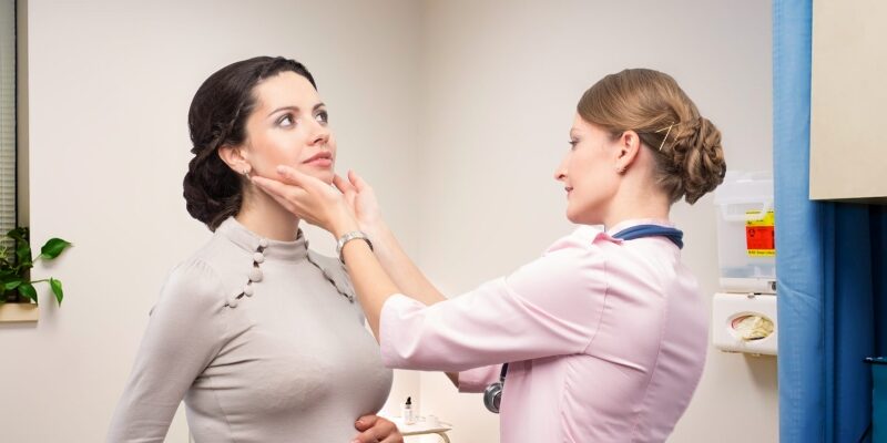 Doctor endocrinologist checking thyroid pregnant